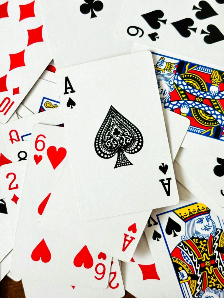 A scattered deck featuring the Ace of Spades and various playing cards.