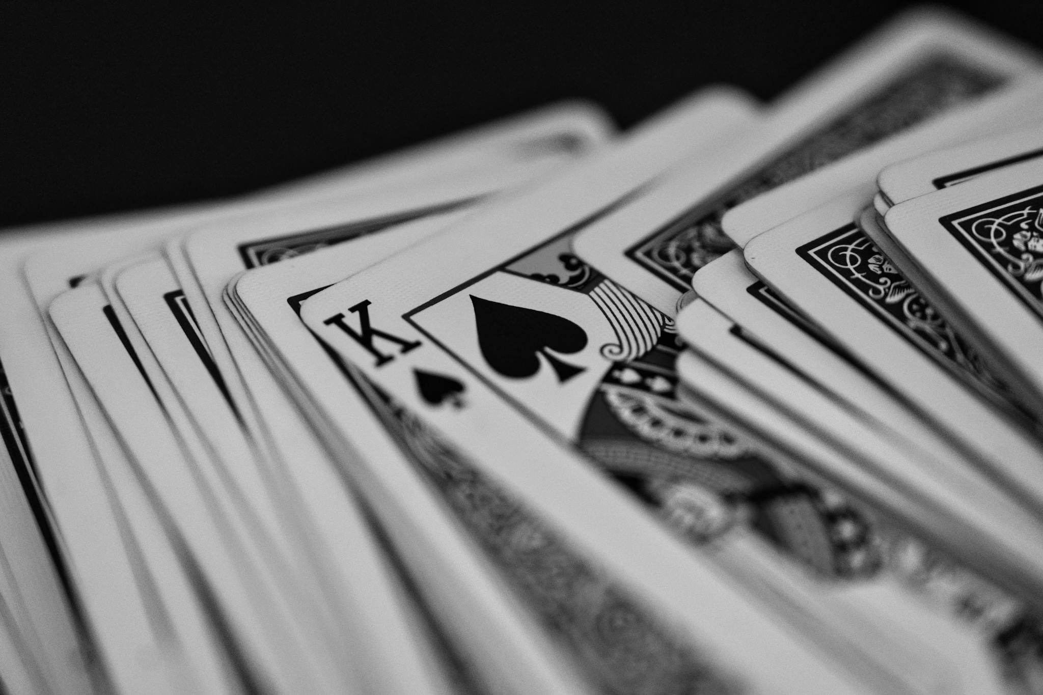 Black and white close-up of a deck of playing cards featuring the King of Spades.